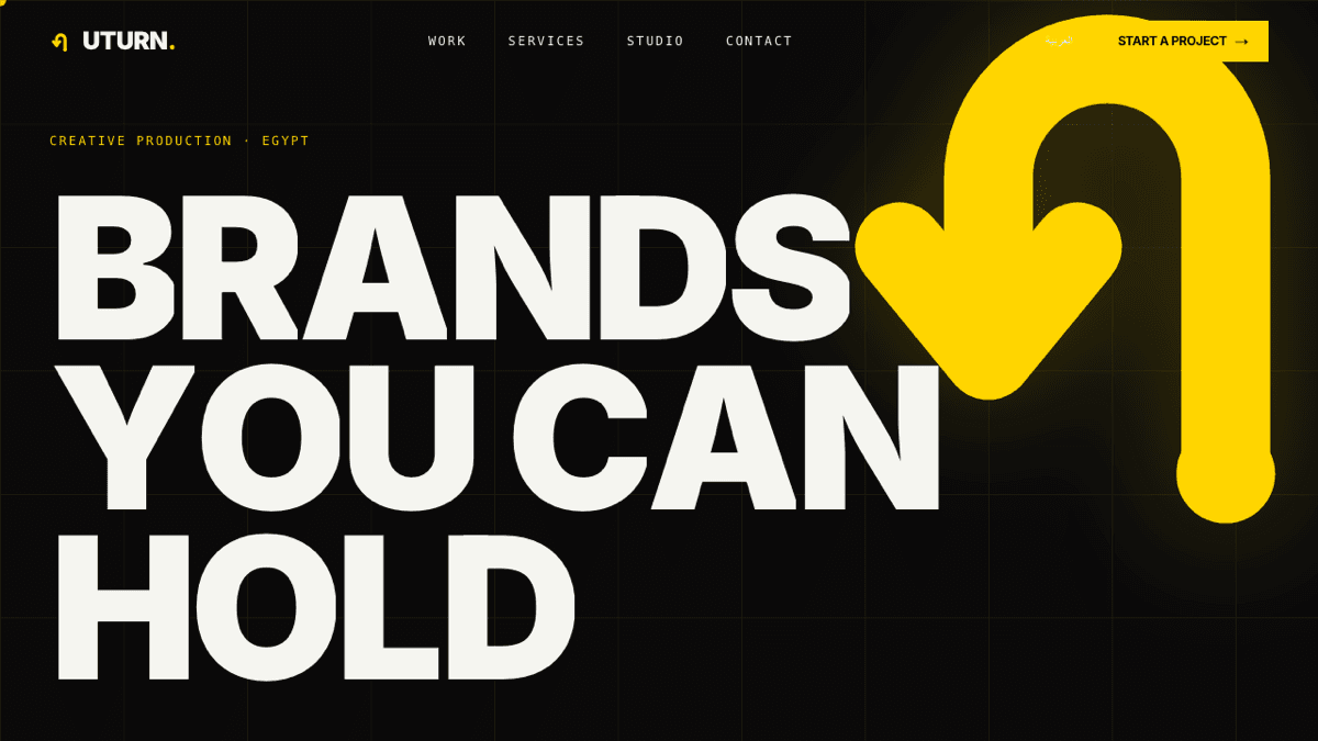 UTURN. Advertising — bilingual EN/AR creative-production studio site, heavy yellow wordmark on black with a U-turn arrow mark.